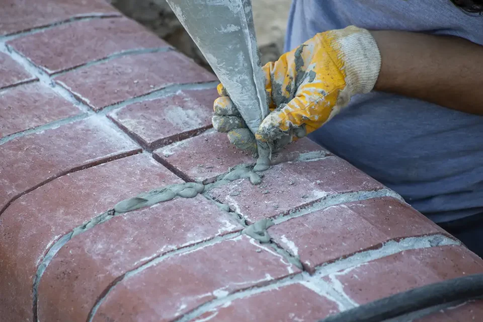piping new grout into brick